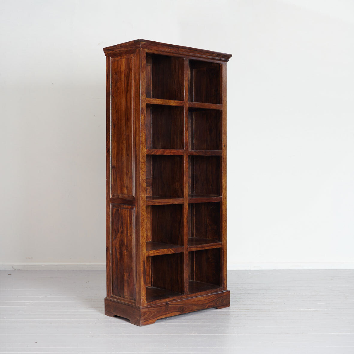 Wooden bookshelf with multiple shelves on a white background
