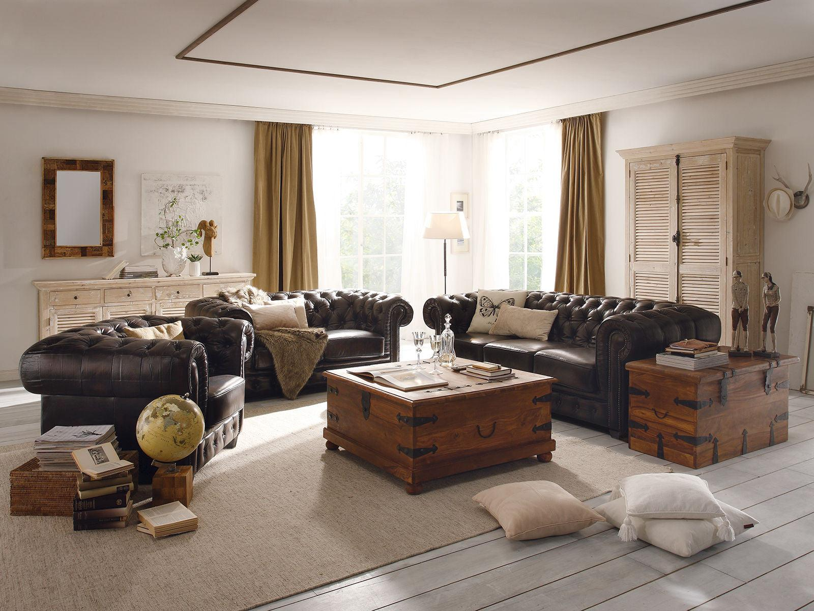 Lifestyle image of a complete Chesterfield 3+1+1 sofa set in a traditional living room - handcrafted leather furniture India