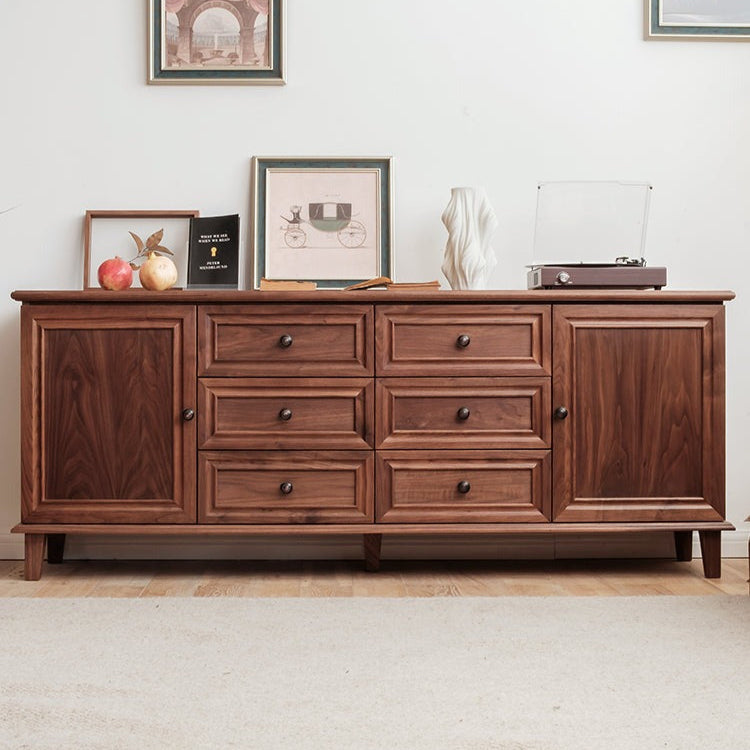 Wooden sideboard with decorative items in a room setting