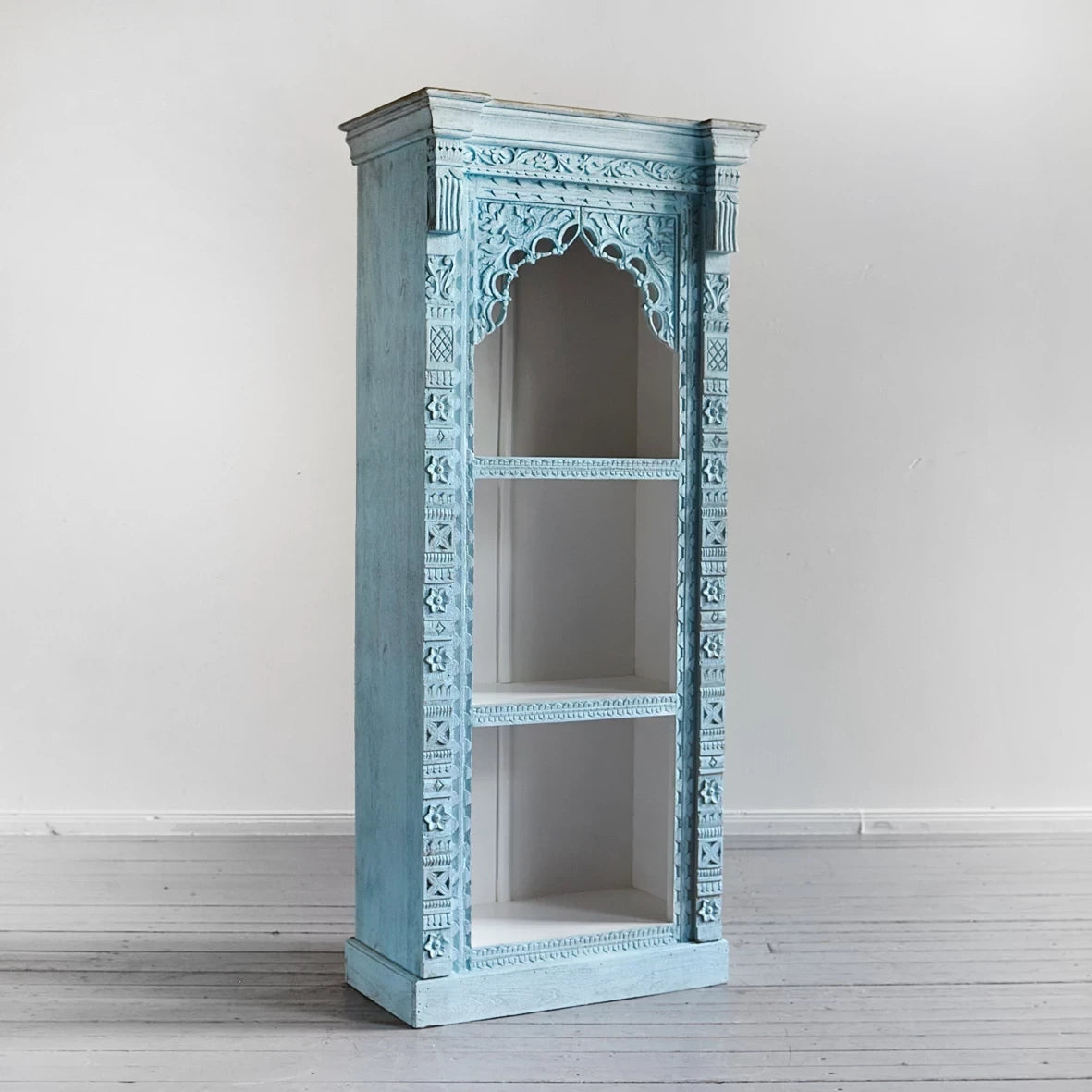 Hand‑carved mango wood jharokha bookcase in blue distressed finish, 187 × 80 × 48 cm.