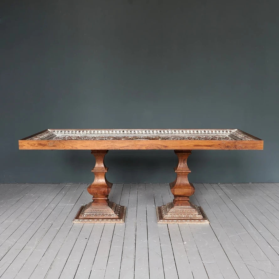 Large 6‑8 seater wooden dining table with carved apron and legs, natural finish.