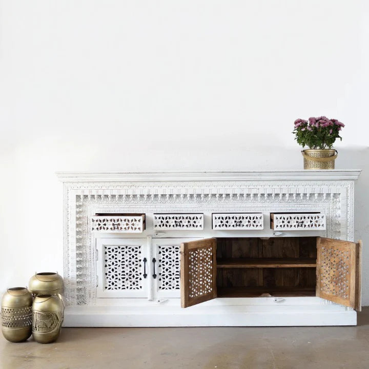 hand carved sideboard, mango wood sideboard, distressed white sideboard, floral carved sideboard, openwork sideboard, 4 door sideboard, 4 drawer sideboard, buffet sideboard, indian carved furniture, storage sideboard, dining room buffet, living room sideboard, entryway sideboard, statement sideboard, large sideboard, handmade sideboard, artisan made sideboard, premium wood buffet, quality wood furniture, durable sideboard, sturdy buffet, timeless sideboard, elegant buffet, grand sideboard, heirloom buffet,