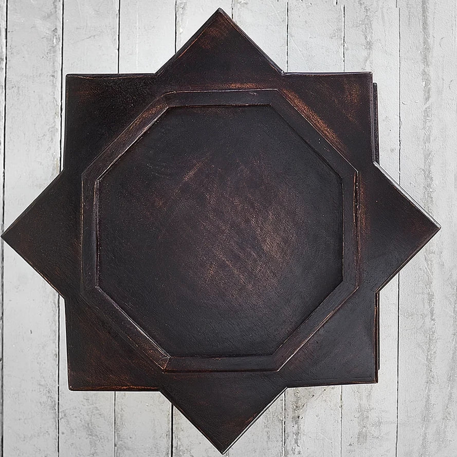 Decorative wooden wall art with geometric design on a light wooden background