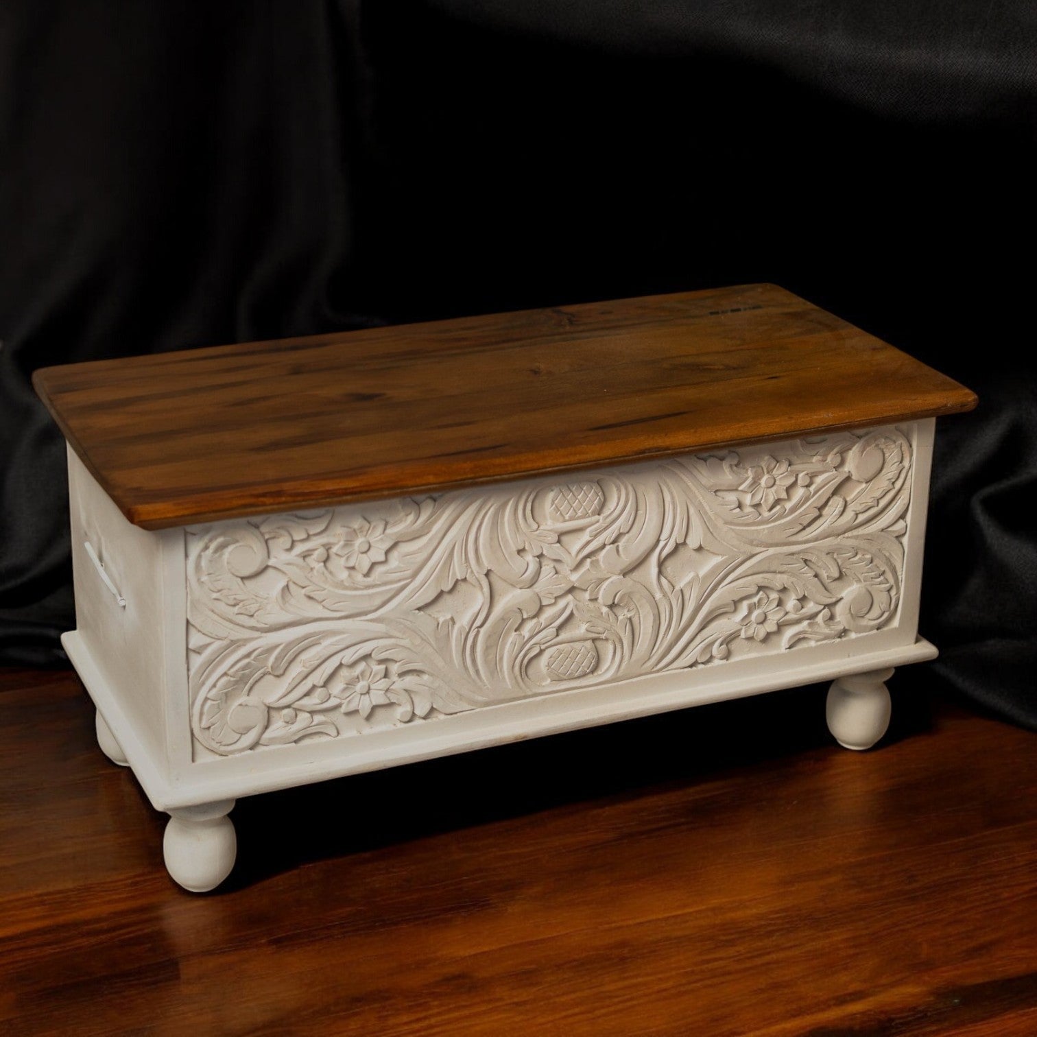 Handcrafted wooden trunk box styled as antique decor with artisan carvings and rustic charm.