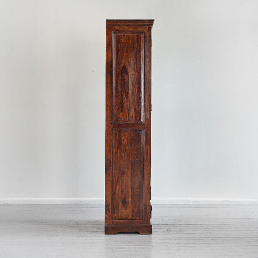 Tall wooden cabinet against a white wall