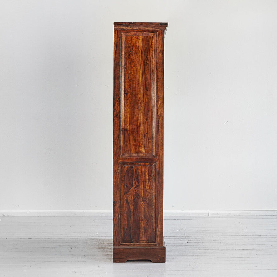 Tall wooden cabinet with a single door on a white background