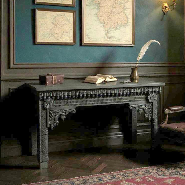 Vintage office with ornate desk, chair, and wall maps.
