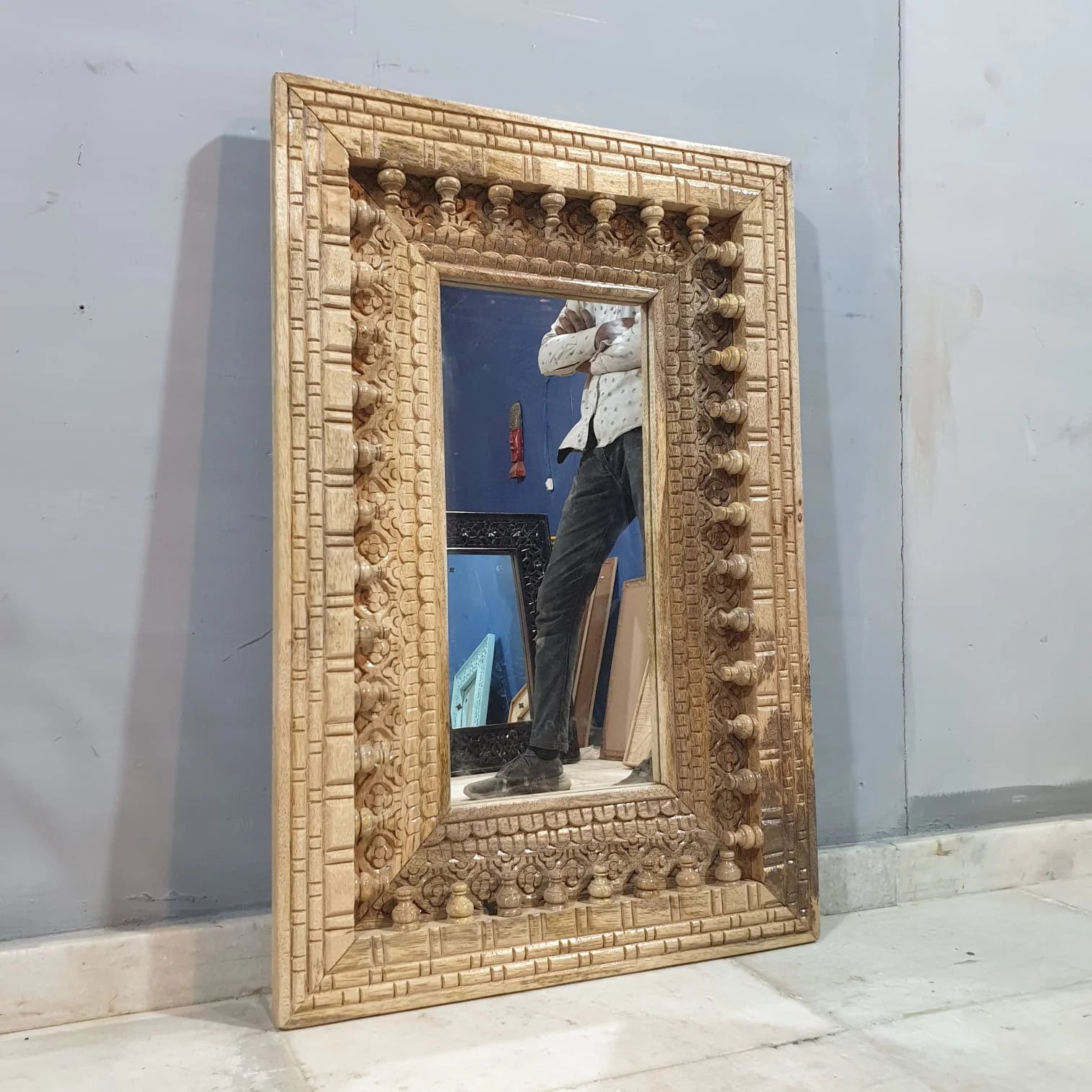 mango wood mirror, carved mirror, natural wood mirror, wall mirror, statement mirror, rustic mirror, architectural mirror, traditional mirror, handmade mirror, artisan mirror, premium mirror, quality mirror, durable mirror, elegant mirror, unique mirror, decorative mirror, focal piece mirror, handcrafted in india, sustainable mango wood, natural wood finish, honey wood, clear coating, hand carved frame, ball and spindle carving, scrolling foliage, basketweave pattern, brick pattern border, dimensional carvi