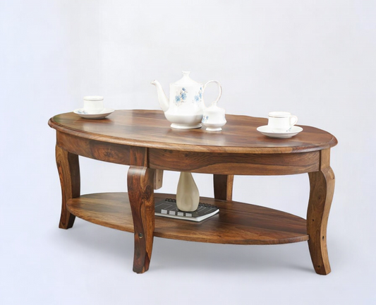 Oval coffee table with a smooth walnut finish and decorative accents on top.
