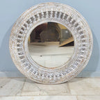 mango wood mirror, carved mirror, round mirror, whitewash mirror, oriental mirror, wall mirror, statement mirror, circular mirror, coastal mirror, bohemian mirror, handmade mirror, artisan mirror, premium mirror, quality mirror, durable mirror, elegant mirror, unique mirror, decorative mirror, focal piece mirror, handcrafted in india, sustainable mango wood, whitewash finish, white wash, warm wood undertones, hand carved frame, ball and spindle carving, ornamental garlands, concentric circles, basketweave p