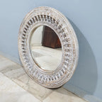 mango wood mirror, carved mirror, round mirror, whitewash mirror, oriental mirror, wall mirror, statement mirror, circular mirror, coastal mirror, bohemian mirror, handmade mirror, artisan mirror, premium mirror, quality mirror, durable mirror, elegant mirror, unique mirror, decorative mirror, focal piece mirror, handcrafted in india, sustainable mango wood, whitewash finish, white wash, warm wood undertones, hand carved frame, ball and spindle carving, ornamental garlands, concentric circles, basketweave p