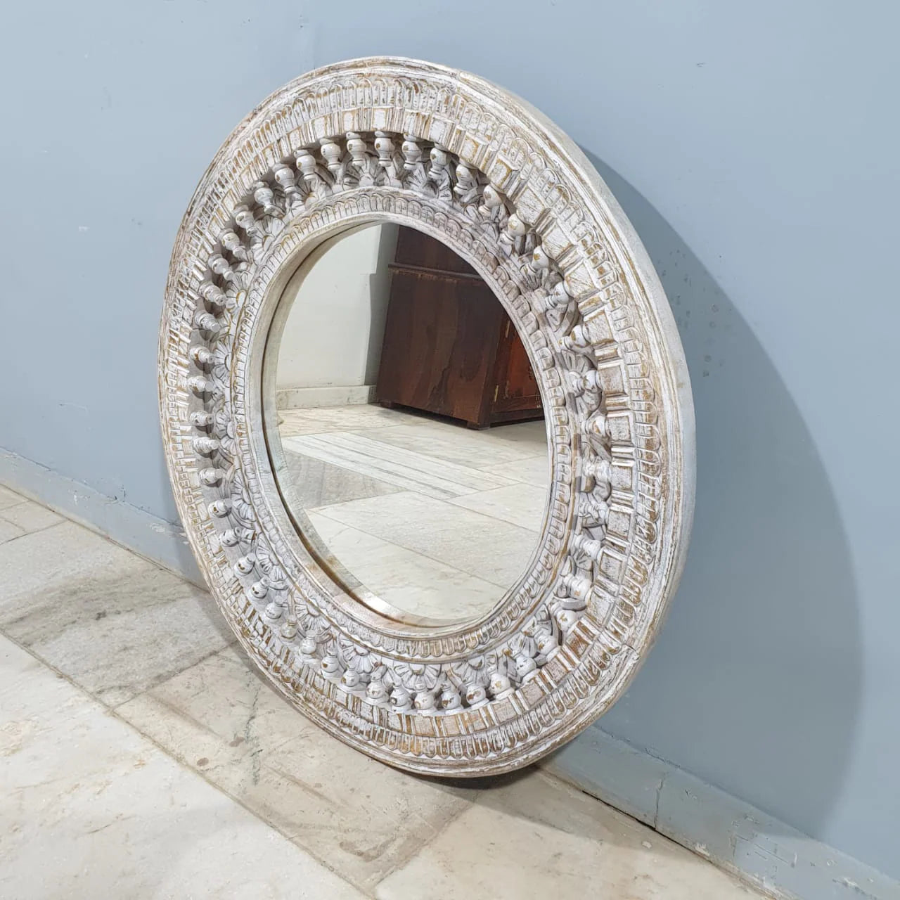 mango wood mirror, carved mirror, round mirror, whitewash mirror, oriental mirror, wall mirror, statement mirror, circular mirror, coastal mirror, bohemian mirror, handmade mirror, artisan mirror, premium mirror, quality mirror, durable mirror, elegant mirror, unique mirror, decorative mirror, focal piece mirror, handcrafted in india, sustainable mango wood, whitewash finish, white wash, warm wood undertones, hand carved frame, ball and spindle carving, ornamental garlands, concentric circles, basketweave p