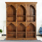 Modern bookshelf in a stylish living room, with a tall bookcase and bookrack on the side.
