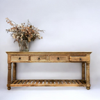 Wooden console table with cane accents for a unique look.
