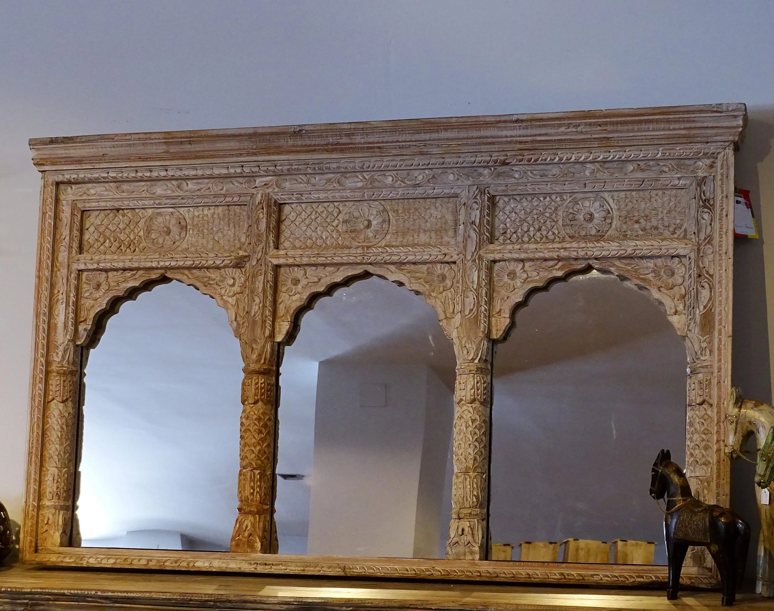 hand carved mirror, wooden frame mirror, vintage mirror, distressed mirror, 3 arch mirror, mehrab arch mirror, triple arch mirror, oversized mirror, large mirror, horizontal mirror, wall mirror, living room mirror, console mirror, decorative mirror, indian furniture, handmade mirror, artisan made mirror, premium wood mirror, quality mirror, durable mirror, sturdy mirror, timeless mirror, elegant mirror, statement mirror, ornate mirror, unique mirror, sculptural mirror, focal piece mirror, handcrafted in ind