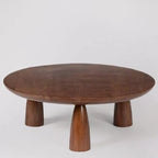 acacia wood coffee table, round coffee table, dark brown table, low coffee table, minimalist table, conical leg table, tapered leg table, scandinavian table, japanese table, modern table, indian furniture, living room table, statement coffee table, handmade coffee table, artisan made table, premium wood table, quality furniture, durable table, sturdy table, timeless table, elegant table, unique table, sculptural table, focal piece table, handcrafted in india, sustainable acacia wood, dark wood finish, natur