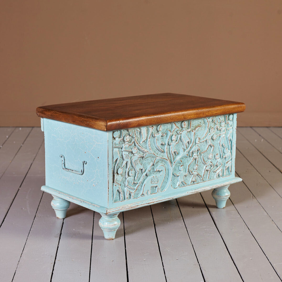 Vintage‑style blue storage trunk on turned legs, lift‑top design.

