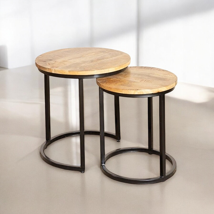 "Nesting tables set in natural wood, space-saving solution for small living rooms."
