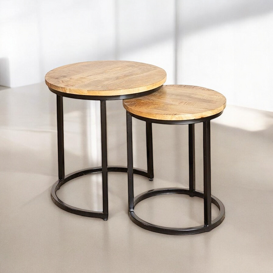 "Nesting tables set in natural wood, space-saving solution for small living rooms."
