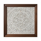 Decorative wall art with intricate patterns in a wooden frame on a white background