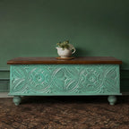 Handcrafted mango wood chest with teal distressed finish, natural wood lid, and ornate carvings.
