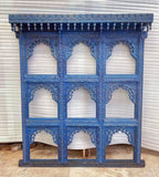 mango wood mirror, jharokha mirror, nine arch mirror, grid mirror panel, indian mirror, blue mirror, distressed blue, carved mirror, wall mirror, statement mirror, palace mirror, scalloped arches, foliate carving, rope border, vine border, baluster brackets, crown cornice, architectural decor, boho decor, global eclectic, vintage inspired, artisan made, handcrafted in india, solid wood frame, large wall mirror, square mirror, entryway decor, living room decor, dining wall, stair landing, heritage decor, ind