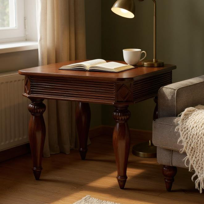Cozy living room with a wooden side table, lamp, and sofa with a blanket.