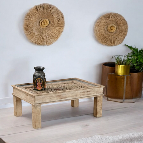 Rustic coffee table with reclaimed wood in a farmhouse-style living room.
