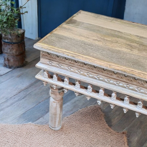 Farmhouse coffee table in a cozy living room with country-inspired decor.
