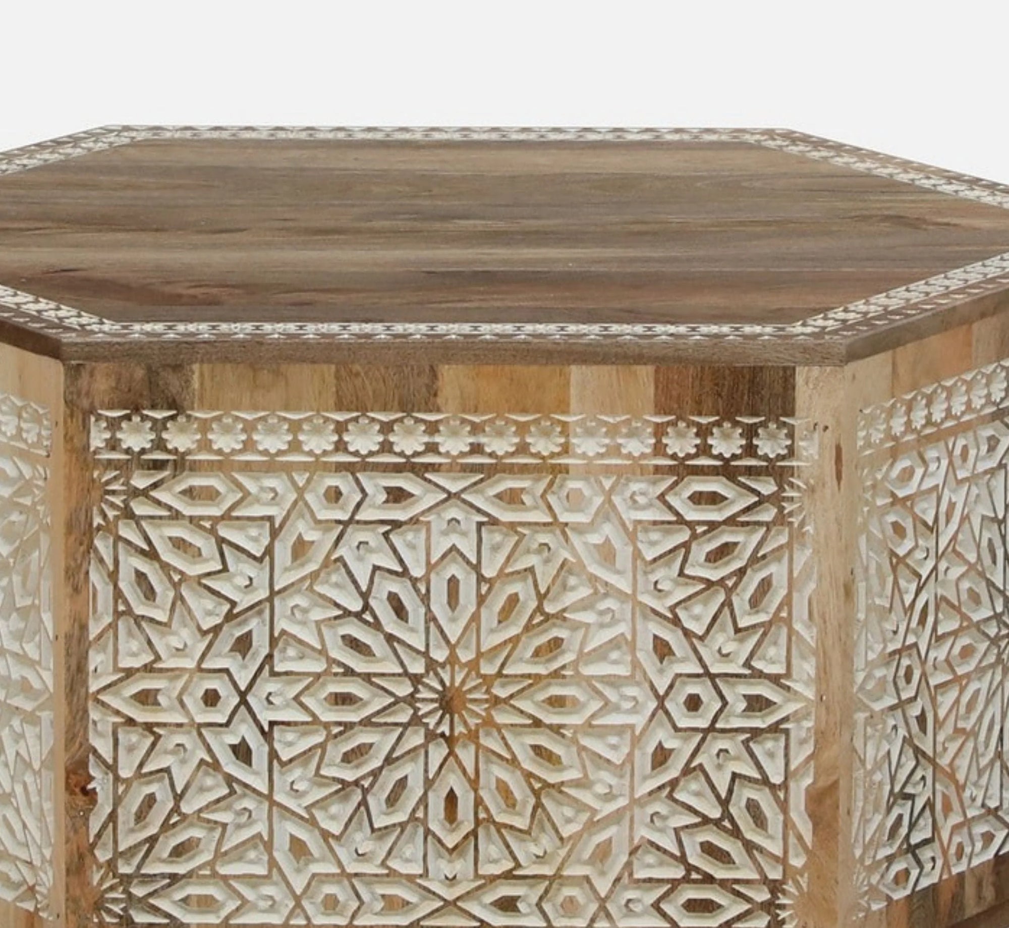 Wooden table with intricate geometric patterns on a white background