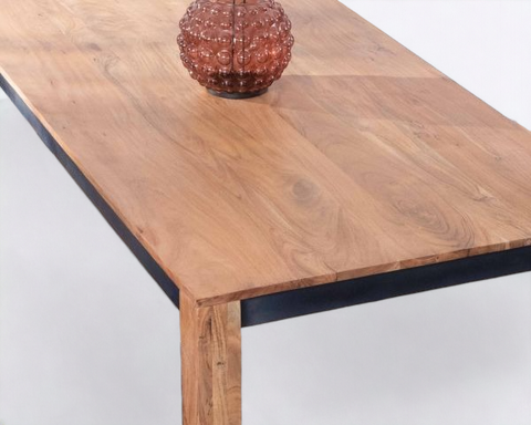 Solid wood dining table with a farmhouse-inspired design, perfect for rustic interiors.
