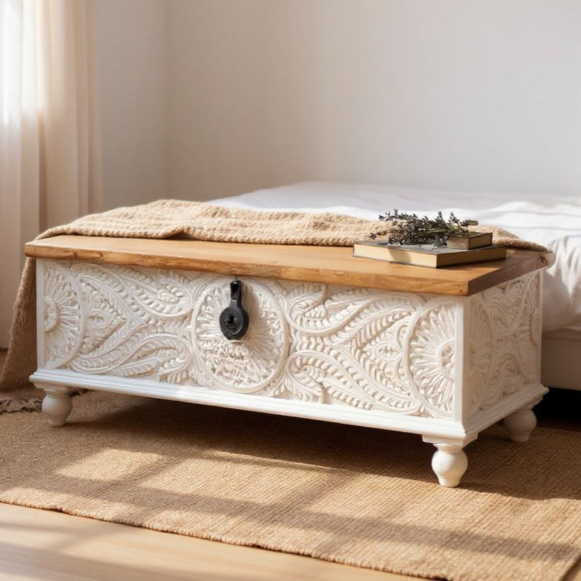 Decorative wooden chest with floral patterns in a bedroom setting