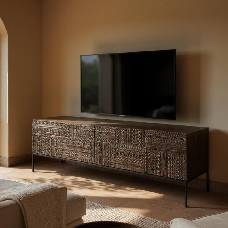 Living room with a textured wooden TV stand and a television mounted on the wall.