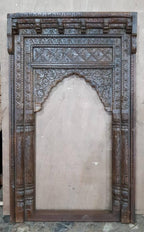 Full‑length hand‑carved mango wood Mughal arch mirror, distressed brown, 210 × 110 × 15 cm; vintage Indian statement piece with floral carvings and layered moldings.

