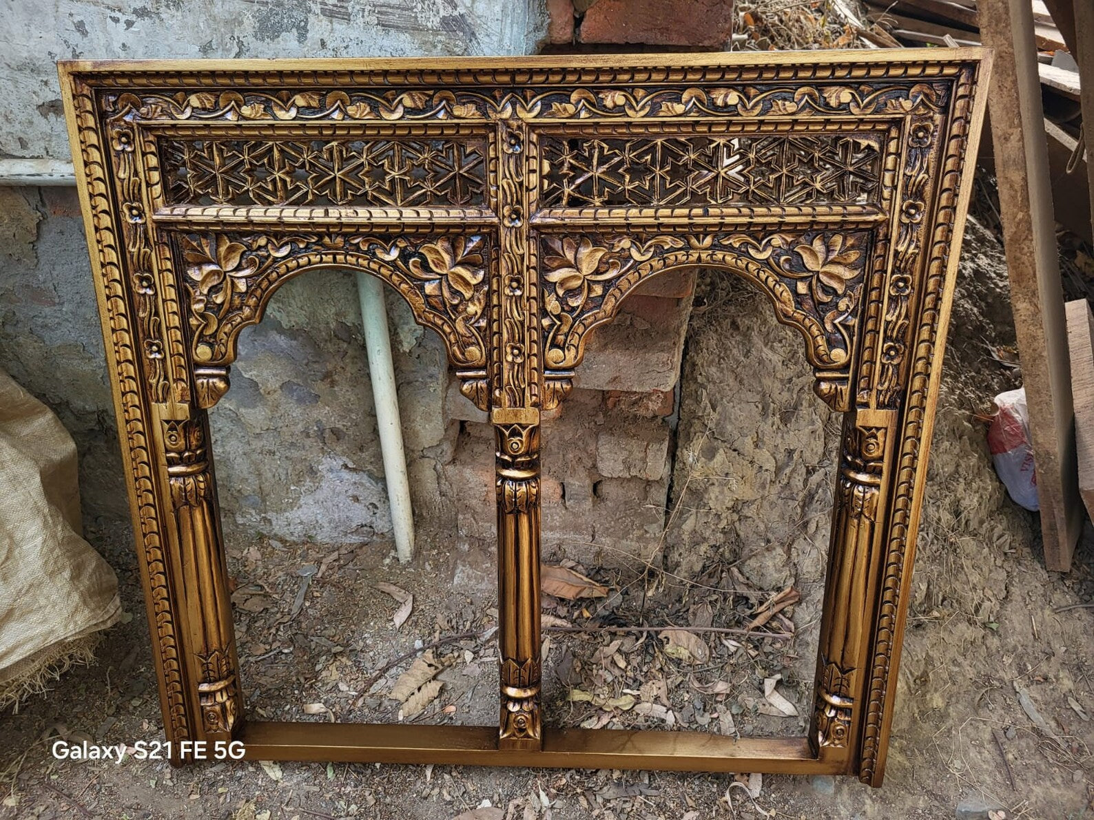 mango wood mirror, jharokha mirror, jaali mirror, carved mirror, twin arch mirror, indian mirror, rustic gold mirror, distressed gold, farmhouse mirror, wall mirror, architectural mirror, palace mirror, scalloped arch, floral carving, spandrels, turned pilasters, rope border, lattice frieze, antique style, vintage inspired, artisan made, handcrafted in india, solid wood frame, statement mirror, entryway mirror, living room mirror, buffet mirror, console mirror, hallway mirror, global eclectic, boho decor, w